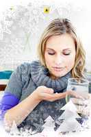 Sick woman taking pills holding a glass of water