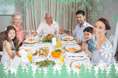Composite image of portrait of an extended family at dining tabl