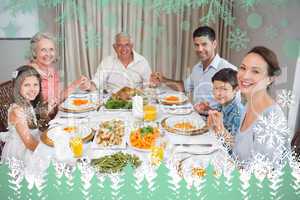 Composite image of portrait of an extended family at dining tabl