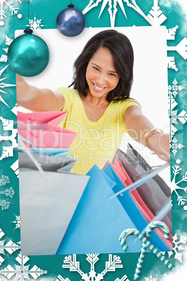 Young woman showing shopping bags