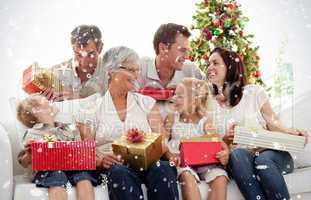 Composite image of family giving presents for christmas