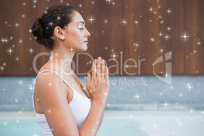 Content brunette in white sitting in lotus pose