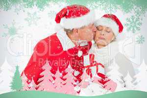 Festive couple smiling and holding gift