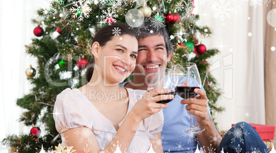 Composite image of lovers drinking wine at homa at christmas tim