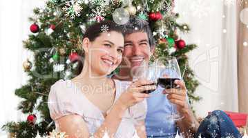 Composite image of lovers drinking wine at homa at christmas tim