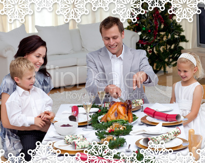 Father cutting a turkey in christmas dinner