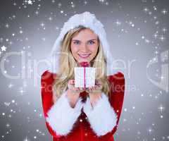 Composite image of pretty girl in santa outfit holding gift