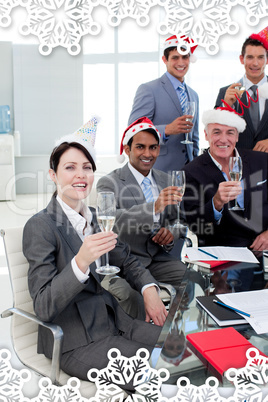 Manager and his team with novelty christmas hat toasting at a pa