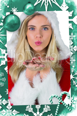 Composite image of pretty girl in santa outfit blowing