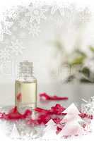 Glass phial and pink petals in a christmas frame