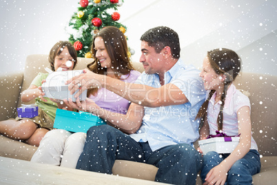 Composite image of family exchanging christmas presents