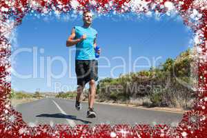 Composite image of athletic man jogging on open road holding bot