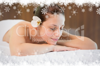 Beautiful woman lying on massage table at spa center