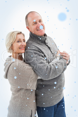 Composite image of happy mature couple in winter clothes