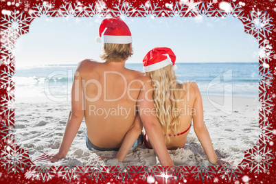 Rear view of couple sitting on beach