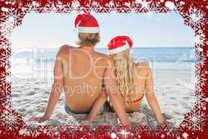 Rear view of couple sitting on beach