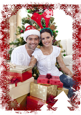 Composite image of happy couple celebrating christmas at home