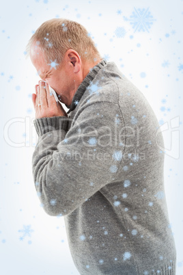 Sick mature man blowing his nose