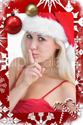 Composite image of woman in santa hat making silence gesture