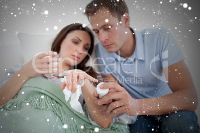 Composite image of attentive husband looking after his wife