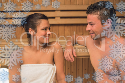 Smiling couple relaxing in a sauna and chatting Smiling couple relaxing in a sauna and chatting