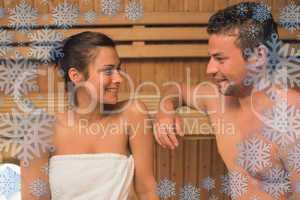 Smiling couple relaxing in a sauna and chatting