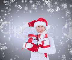 Composite image of festive woman holding gifts