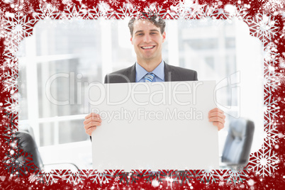 Handsome happy businessman holding placard