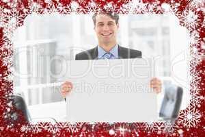 Handsome happy businessman holding placard