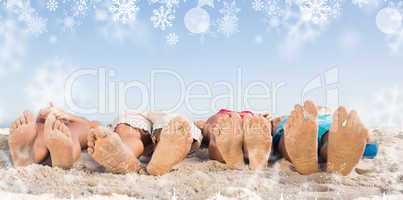 Composite image of feet of friends lying together