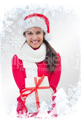 Composite image of beautiful festive woman offering gift