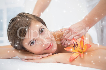 Attractive woman receiving shoulder massage at spa center