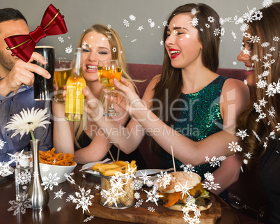 Composite image of friends having dinner together