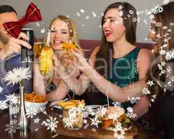Composite image of friends having dinner together