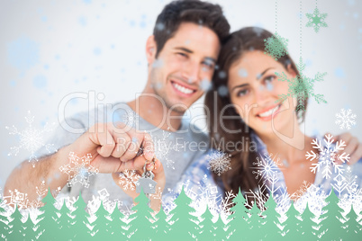 Man and wife holding a key with a house keychain