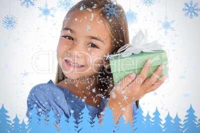 Smiling girl excited while holding a present