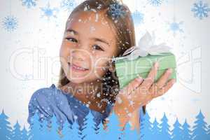 Smiling girl excited while holding a present