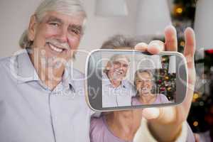 Composite image of hand holding smartphone showing