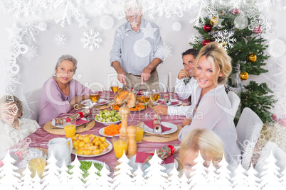 Composite image of happy family at christmas dinner