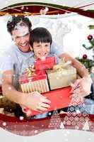 Happy father and son holding christmas presents