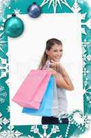 Composite image of portrait of a woman holding shopping bags