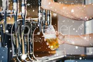 Composite image of barmans arms pulling a pint of beer