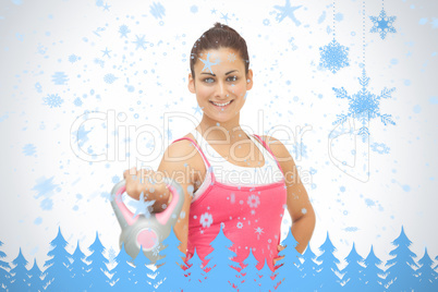 Cheerful sporty brunette holding grey and pink kettlebell