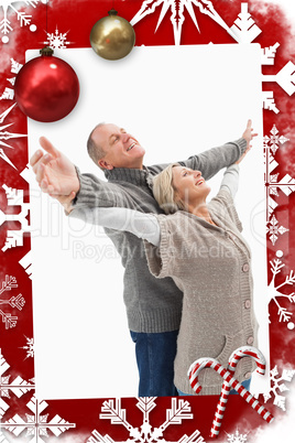 Composite image of happy mature couple in winter clothes