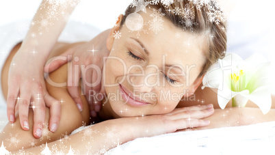 Composite image of young woman enjoying a back massage