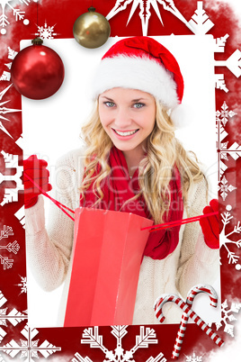 Composite image of festive blonde holding shopping bag