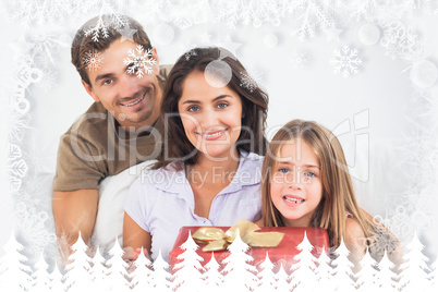 Composite image of parents offering a gift to their daughter