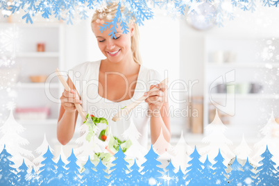 Composite image of gorgeous woman mixing a salad