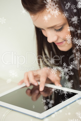 Relaxing girl looking and using a tablet pc on a sofa