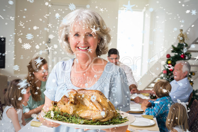 Composite image of happy grandmother with christmas meal